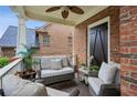Relaxing covered porch with comfortable seating, a ceiling fan, and brick walls for a private atmosphere at 3250 Seven Oaks Dr, Cumming, GA 30041