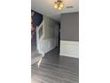 Bright entryway featuring hardwood floors, classic wainscoting, and a staircase at 4160 Post Oak Grv, Atlanta, GA 30349
