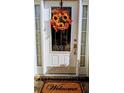 Inviting front door adorned with a colorful wreath, sidelights, and a welcoming doormat at 4160 Post Oak Grv, Atlanta, GA 30349