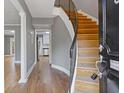 Inviting entryway featuring hardwood floors, curved staircase, and a view into the adjacent kitchen at 5400 Roswell Rd # Apt E6, Sandy Springs, GA 30342