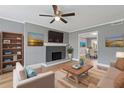 Comfortable living room featuring a decorative fireplace, neutral color palette, and seamless flow to the dining area at 5400 Roswell Rd # Apt E6, Sandy Springs, GA 30342