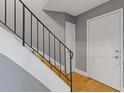 Staircase with modern black railing, neutral wall color, and adjacent door, offering a clean and functional design at 5400 Roswell Rd # Apt E6, Sandy Springs, GA 30342