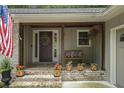 Charming front porch with brick flooring, decorative plants, and cozy seating area at 7265 Hunters Branch Dr, Sandy Springs, GA 30328