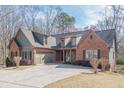Beautiful exterior of a home with brick, siding, well-maintained landscaping, and attached garage at 1765 Dew Pl, Marietta, GA 30064