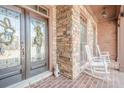 Inviting front porch with stone accents, rocking chairs, and decorative glass front door at 1765 Dew Pl, Marietta, GA 30064