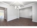 Elegant dining room with hardwood floors and a chandelier at 113 Canal St, Hampton, GA 30228