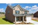 Beautiful two-story brick home with a well-maintained lawn and attached garage at 113 Canal St, Hampton, GA 30228