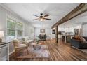 Bright living room with hardwood floors, rustic beam, and a view of the dining area and kitchen at 2109 Allgood Rd, Marietta, GA 30062