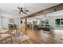 Open-concept living space featuring hardwood floors, a rustic beam, and seamless flow to the kitchen at 2109 Allgood Rd, Marietta, GA 30062