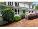 Close up of home showcasing well-manicured landscaping and charming details of the front porch at 4920 Hampton Lake Dr, Marietta, GA 30068