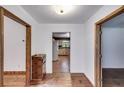 View of the home's hallway featuring hardwood floors and rustic wood door frames at 4985 Watkins Ct, Winston, GA 30187