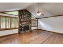 Cozy living room featuring a stone fireplace, hardwood floors and wood-trimmed windows at 4985 Watkins Ct, Winston, GA 30187