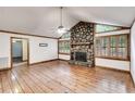 Spacious living room featuring a stone fireplace, hardwood floors, and wood-trimmed windows at 4985 Watkins Ct, Winston, GA 30187