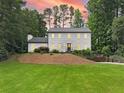 Charming white two-story home with manicured landscaping and beautiful curb appeal at 2885 Laurel Green Ct, Roswell, GA 30076
