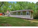 Attractive exterior of a one-story home featuring a lush green lawn at 3852 Drew Campground Rd, Cumming, GA 30040