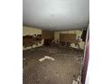 A dirty bedroom with damaged walls and debris on the floor at 711 Alfred Nw Rd, Atlanta, GA 30331