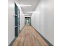Long hallway with neutral toned flooring and modern lighting at 775 Juniper Ne St # 210, Atlanta, GA 30308