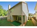 View of the backyard featuring a covered patio and fenced yard at 2550 Trelipe Dr, Lawrenceville, GA 30044