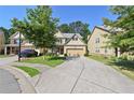 Charming two-story home with a brick front, inviting entrance, and a two car garage at 2550 Trelipe Dr, Lawrenceville, GA 30044