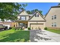 Charming two-story home with a brick front, inviting entrance, and a two car garage at 2550 Trelipe Dr, Lawrenceville, GA 30044