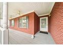 Inviting covered front porch with brick columns, white railings, and ceiling fans at 528 Savannah Rose Way, Lawrenceville, GA 30045