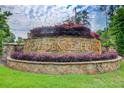 Stone community sign for Providence Harbor with colorful landscaping and lush green grass at 332 Warwick Pl, Mcdonough, GA 30253