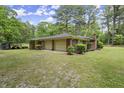 Attached two-car garage offering convenience and ample parking space, surrounded by lush greenery at 3630 Spot Rd, Cumming, GA 30040