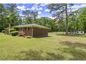 Brick home with a green lawn, featuring a view of the spacious side yard at 3630 Spot Rd, Cumming, GA 30040