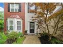A welcoming entryway with a neatly landscaped garden and a charming black door with a wreath at 1100 Carrington Pkwy, Villa Rica, GA 30180