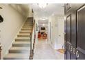 Inviting entryway with staircase, neutral walls, and a glimpse of the living area at 1386 Sheffield Glen Ne Way, Atlanta, GA 30329