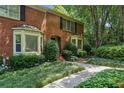 Lovely brick townhouse featuring a lush, landscaped front yard and classic architectural details at 1386 Sheffield Glen Ne Way, Atlanta, GA 30329