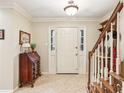 Bright foyer with tile flooring, staircase, and classic decor, creating a welcoming entrance at 1386 Sheffield Glen Ne Way, Atlanta, GA 30329