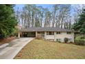 Charming ranch-style home with a long driveway and mature trees surrounding the property at 2151 Zelda Ne Dr, Atlanta, GA 30345