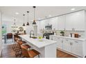 Modern kitchen features quartz countertops, a large island, and stainless steel appliances at 598 Taylor Se Dr, Smyrna, GA 30080