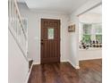 Inviting foyer with hardwood floors, staircase, and a view of a cozy window seat at 101 Swanton Hill Ct, Decatur, GA 30030