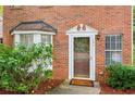 Close-up of the front door with brick facade and manicured shrubbery at 101 Swanton Hill Ct, Decatur, GA 30030