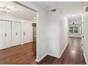 Hallway featuring hardwood floors and doors to a walk-in closet, laundry, and living areas at 101 Swanton Hill Ct, Decatur, GA 30030