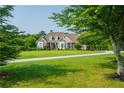 A long driveway to a beautiful brick home with a manicured lawn and mature shade trees at 815 Spring View Ct, Covington, GA 30014