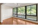 Living room with hardwood floors, ceiling fan and large window with green outdoor views at 1800 Clairmont Lk # 216, Decatur, GA 30033