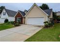 Inviting home showcasing a well-maintained lawn and a two-car garage at 225 Kentshire Pl, Lawrenceville, GA 30044