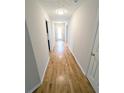 Bright hallway featuring hardwood floors, neutral paint, and modern lighting at 225 Kentshire Pl, Lawrenceville, GA 30044