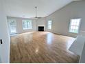 Spacious living room with hardwood floors, a fireplace, and abundant natural light at 225 Kentshire Pl, Lawrenceville, GA 30044