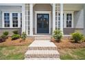Home front entrance with brick steps, columns, and a charming double-door entry at 591 Brashy St, Woodstock, GA 30188