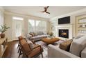 Bright living room with a fireplace, built-in shelves, and a stylish ceiling fan, creating a cozy gathering space at 1365 Hawthorne Se Ave, Smyrna, GA 30080