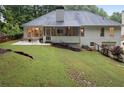 A spacious backyard featuring a patio, screened porch, and mature trees, offering a private outdoor retreat at 3543 Pine Grove Dr, Douglasville, GA 30135