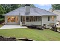 Back of a two-story home with a gray roof, screened-in porch, and a well-maintained lawn at 3543 Pine Grove Dr, Douglasville, GA 30135