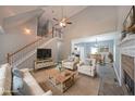 Open-concept living area with fireplace and staircase, seamlessly connects to the dining area, offering a spacious and inviting atmosphere at 36 Laurel Ne Way, White, GA 30184
