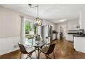 Bright dining area with stylish lighting, hardwood floors, and sliding glass doors to the backyard at 385 Russell Ridge Dr, Lawrenceville, GA 30043