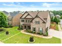 Charming two-story home showcasing a lush green lawn, stone walkway and professional landscaping at 4015 Roberts Crest Ln, Suwanee, GA 30024