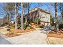 Suburban home with a long driveway and a well-manicured lawn and landscaping at 4506 Westcliff Ne Trce, Roswell, GA 30075